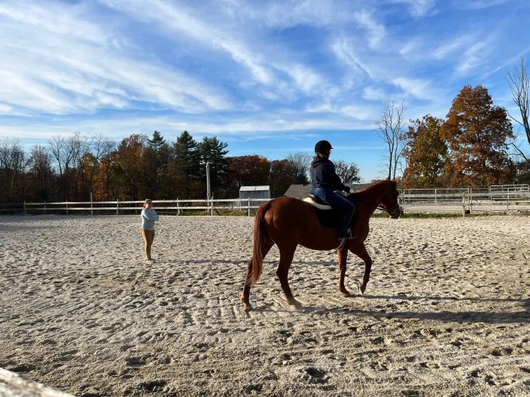 Clarice teaching a horseback riding lesson to a student